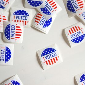 Image of several "I voted" stickers laid out on a table.