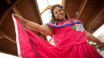 Image of woman smiling in bright cultural dress.