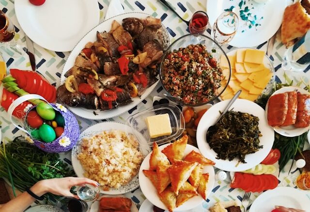 A feast of colorful food dishes spread on a table.