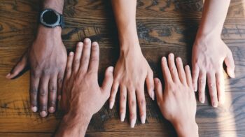 Image of five hands of different skin colors.