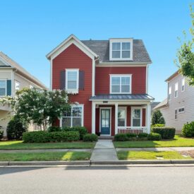 Red house surrounded by neighborhood homes.
