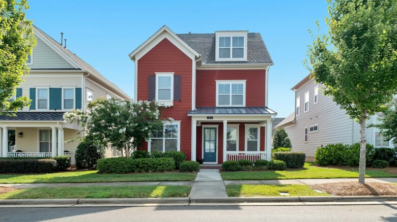 Red house surrounded by neighborhood homes.